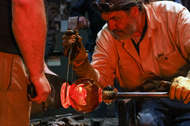 Don Friel working on a trial run of a large Millville Rose Paperweight at the end of a blowpipe.