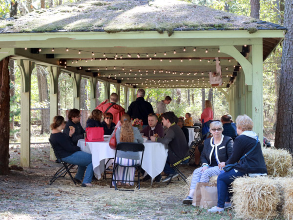 Visitors sit in the Beer and Wine Garden at the Festival of Fine Craft.