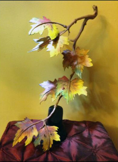 A branch with autumn leaves. A wood carving by David & Barbara Shields.