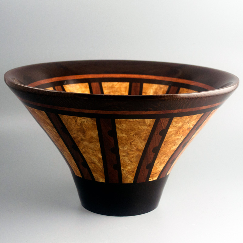 A tall wooden bowl with tan, mahogany, and deep brown striping by Scott Foster.