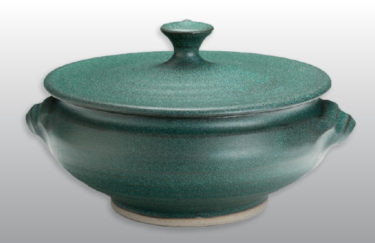 A stout, wide lidded green vessel by Amy Peseller.