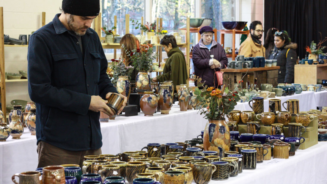 A visitor explores the ceramic selection at the WheatonArts Holiday Studio Sale.
