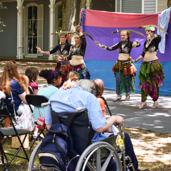 Fantasy Faire 2019 dancers perform in front of a crowd of attendees in front of the American Museum of Glass.