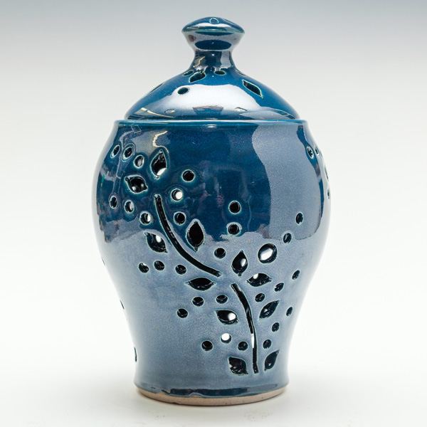 An item from the Holiday Studio Sale. This piece is a blue flower hole patterned vase by potter Phyllis Seidner.