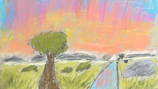 A pastel painting used for the Introduction to Soft Pastels for Young Artists workshop of a tree next to a road with tall grass around it, and a rock on the right side of the road, in front of a bright skyline painted yellow, pink, purple, red, and blue. Below the skyline is a row of looming grey mountains.
