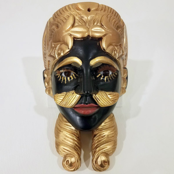 A black & gold mask that is a part of the Down Jersey Folklife Center exhibit: The Good, the Evil, and the Funny: Ritual & Mask Dance of Latin America.