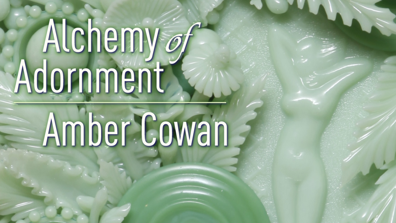 "Alchemy of Adornment: Amber Cowen" is in front of a sculpture by the Alchemy of Adornment exhibit artist Amber Cowen. showing a wall of light green glass flowers.