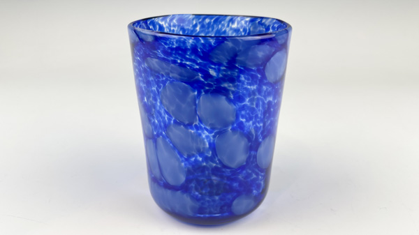 A deep blue tumbler with a spackle pattern and several light bubbles is one possible creation in the tumbler make-your-own experience.