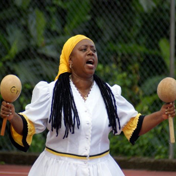 Image of Eleanor Castillo Bullock, holding musical shakers in each hand.