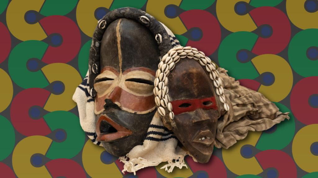 Image of two masks from the "Ceremonies in Circles" exhibit. The mask on the left is black with red lips and a round red mask around the the eyes and nose. Around the eyes is smaller beige round mask. There is more beige outlining the bottom of the red mask. There is also a matching vertical stripe that starts at the top of the entire black mask and extends through the middle of the forehead to the beige part of the red mask stopping right before the red mask ends around the nose. Around the top of the black mask is a long cylindrical black head piece with six small white cowrie shells along the front side of it. A white cloth with fringe and three dark blue stripes towards the top and middle of it rests around the entire mask. The mask on the right side of the image is smaller than the one on the left. This mask is black with light brown highlights and speckles throughout the base. This mask has white teeth with a gap in the center and a thin, rectangular red mask around the eyes. This mask also has a cylindrical head piece draped around the top of it. This piece is the same color as the rest of the base of the mask, but is covered in three rows of small white cowrie shells lined up next to one another alongside the top and front side of the head piece. Behind this mask is another cloth. This cloth has a pattern of gray and beige stripes. These pieces are in front of a background that is comprised of yellow, red, and green thick "c"-shaped half circles that connect with each other at the end of the half. The shapes mirror each other as they make a vertical curving pattern in six rows throughout the banner. The colors of the shapes follow a green, yellow, and red pattern. Each shape has a small blue circle in the center gap.