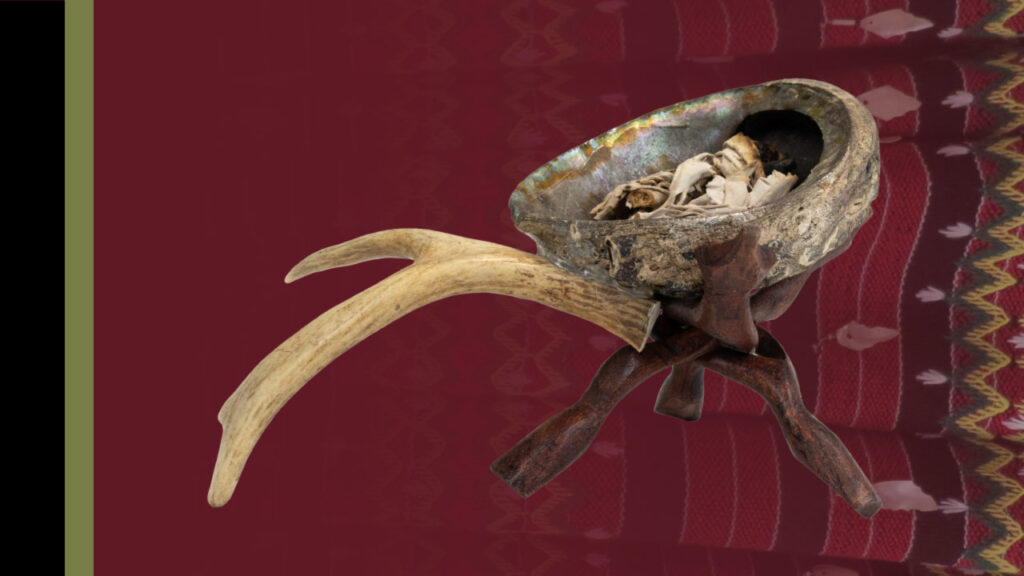 Image of the banner for Communities and Cultures of Down Jersey. The left side of the banner has a black vertical stripe followed by a green stripe. To the right of the stripes is a dark red background that becomes more transparent as it reaches the right of the banner. Underneath the transparent section is an image of a patterned textile. On the right side of the image is a photo of of a piece from the Down Jersey Folk Life Center exhibit. The piece is comprised of three interlocking pieces of wood holding up a stone bowl-like piece filled with large strands. Attached to the right side of the bowl is a large pale piece of wood that branches off into two at the top.