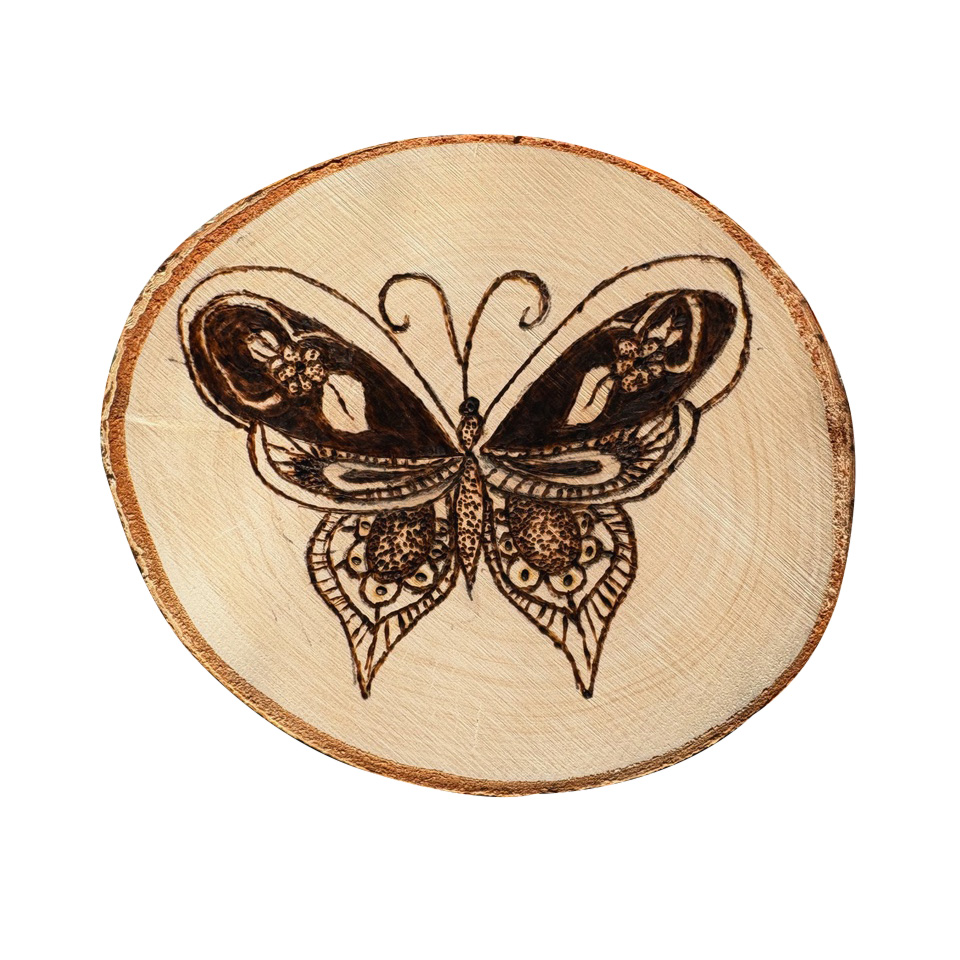 Image of a beige, circular piece of wood with a butterfly design burnt into the center.
