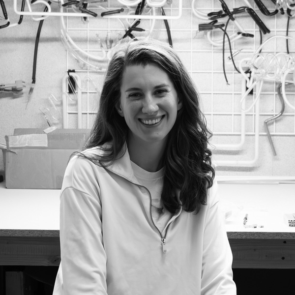 Grayscale headshot image of Erin Hoffman. Erin has long hair that is wavy towards the ends.